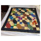 Machine stitched and custom quilted measures 42x50
