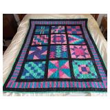 Machine stitched and custom quilted measures 51x63