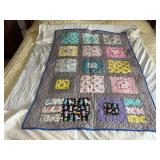 Machine stitched and custom quilted measures 38x57 Minky back