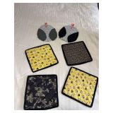 Four hot pads and a pair of oven mitts