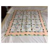 Machine stitched and custom quilted measures 40x48