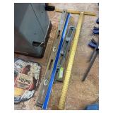Assortment of levels, straight edges and drywall square