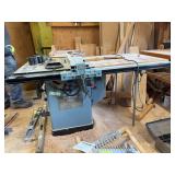 Delta Unisaw 10 inch tilting arbor saw includes extended tables and router with assorted guides and accessories