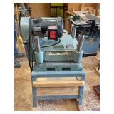 Delta heavy duty commercial 12 inch thickness planer on work stand with rollers