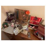 Dresser top items, including assorted costume jewelry, small Lane cedar chest