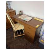 Small writing desk and antique wooden chair with a few desk supplies include