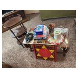 Hard rock maple drop leaf coffee table with binoculars, coloring books and pencils, some decor items and a small three￼ shelf side table