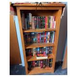 Small solid wood bookshelf, full of Stephen King and Catherine Coulter reading novels