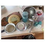Small group of collectibles includes stove pipe cover, enamelware, meat grinder, blue ball jar, glass insulators, and purple bottles