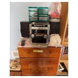 Phillips stereo with two speakers, CD assortment and small three drawer chest of drawers