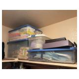 Two plastic totes full of bathroom towels and some additional linens