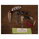Four pocket knives, including Mossy Oak, Gerber, Kershaw, and a souvenir knife