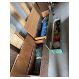 Three wooden storage boxes, large has a tent, a tarp plus additional camping type items and another tarp