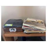 Jensen tabletop record player and stack of vintage vinyl records