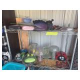 Two upper shelves of yard and garden art