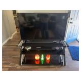 49 inch Vizio flatscreen TV, with triple shelf entertainment stand, and Sony DVD VHS player