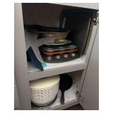 Miscellaneous kitchen cookware, including fajita skillet, pie plates, salad spinner, muffin tins, baking pans