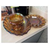 Three pieces of amber colored carnival glass