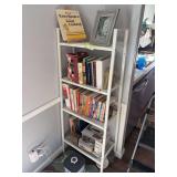 White metal shelf, full of cookbooks