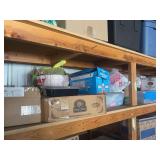 Upper shelf full of craft items includes pinecones, horseshoes, seashells, doll heads