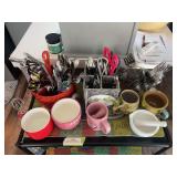 Assorted silverware and coffee mugs