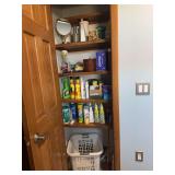 Contents of closet includes cleaning supplies, laundry basket, etc