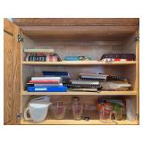 Tupperware batter bowls, Pyrex glass measuring cups, cookbooks and a bunch of straws
