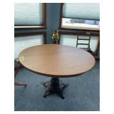 42" round oak table cast iron base marked THE MERLE & HEANEY NFG CO CHICAGO The base has been repaired.