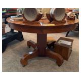 45” round oak dining table w (3) 9” leaves on wooden wheels