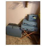 Vintage hard sided suitcases and luggage rack