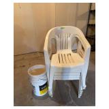 Six plastic lawn chairs and two 5 gallon buckets for your garbage