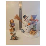 M.I. Hummel porcelain figurine titled 'Making New Friends,' featuring a boy in winter clothing greeting a snowman on a sled, Model Number: HUM 2002 and young boy skiing, titled 'Just One Ski Left' (BH