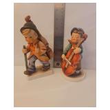 Goebel Hummel 'Sweet Music' figurine (Model #186), depicting a boy playing a cello. vintage Goebel Hummel 'Little Cellist' porcelain figurine, specifically identified as model #89/1, which depicts a y