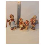 Goebel Hummel figurine, specifically the 'Little Scholar' boy, Model Number: 80.  M.I. Hummel piece titled 'Doll Mother' (Hum 67), featuring a young girl tending to a doll in a carriage.  'Weary Wande