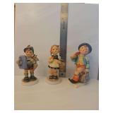 Goebel Hummel 'Merry Wanderer' figurine, identified as model Hum 11 2/0.   Goebel Hummel figurine, specifically the 'Sister' model, which is a popular porcelain collectible designed based on artwork b