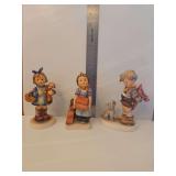 Goebel M.I. Hummel porcelain figurine titled 'Not For You' (Hum 317), featuring a boy with a bouquet of flowers and a dog. Vintage Goebel Hummel porcelain figurine titled 'The Builder', Model Number: 