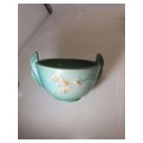 Roseville Pottery bowl from their 'Ixia' line, featuring a green glaze with pale yellow and pink floral buds