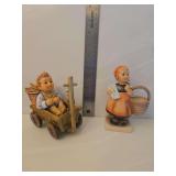 Goebel Hummel figurine titled 'I'm Carefree,' cataloged as HUM 633.  M.I. Hummel porcelain figurine titled 'Meditation' (model number HUM 13), featuring a young girl holding a letter and a basket