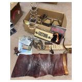 Small group of western decor includes chaps, wall hangings, antique stirrups, spurs, bits, movies, and a book