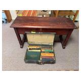 Old suitcase full of books and piano bench