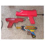 Tin Cosmic Ray gun, Wyandotte Toys water pistol and Newell Atomic 5 pistol