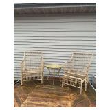 Reed patio set with two chairs and cushions, table