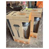 Two 4 count packs of solar yard lights