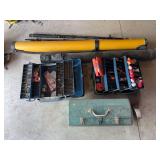 Assortment of fishing poles and tackle boxes and pole carriers