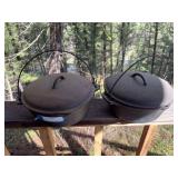 Two number eight cast iron Dutch ovens