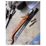 Machete with tooled leather sheath and two fire starters