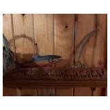 Wall shelf with carved elephants, brass bell with feather design and fish