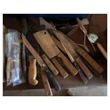 Assortment of kitchen knives and sharpening stones and tools