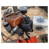 Canon film camera with large lens and Nikon cool pics 5700 digital camera