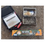 New in box pop-up fire pit plus small stainless steel camp cook stove, and additional butane cook stove in carrying bag